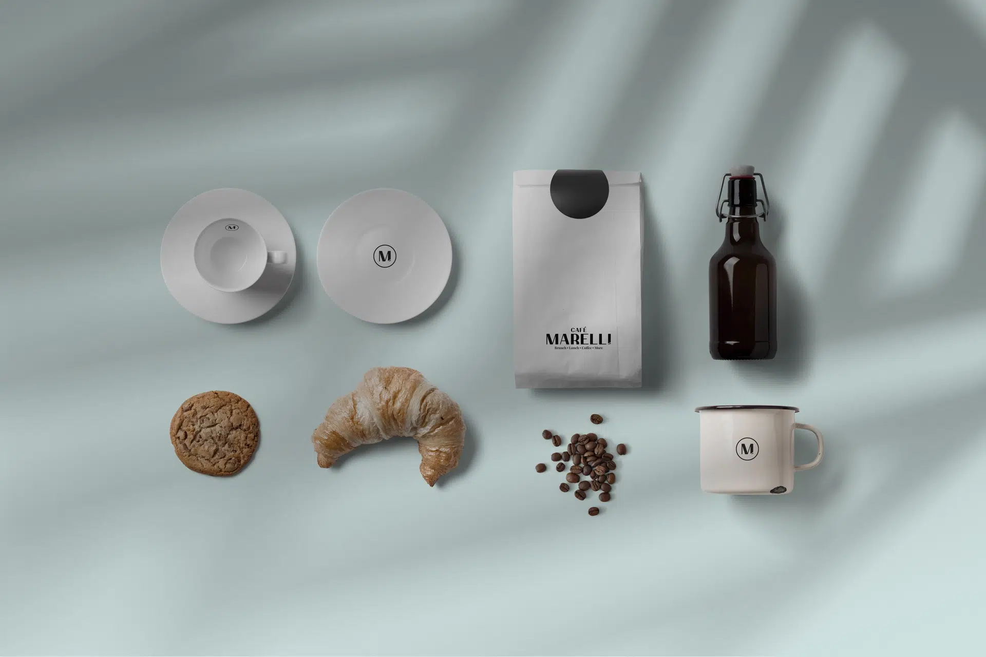 Marelli cafรฉ brand identity featuring warm colors, bold type, and soft industrial details inspired by French bistros and Maltese expression.