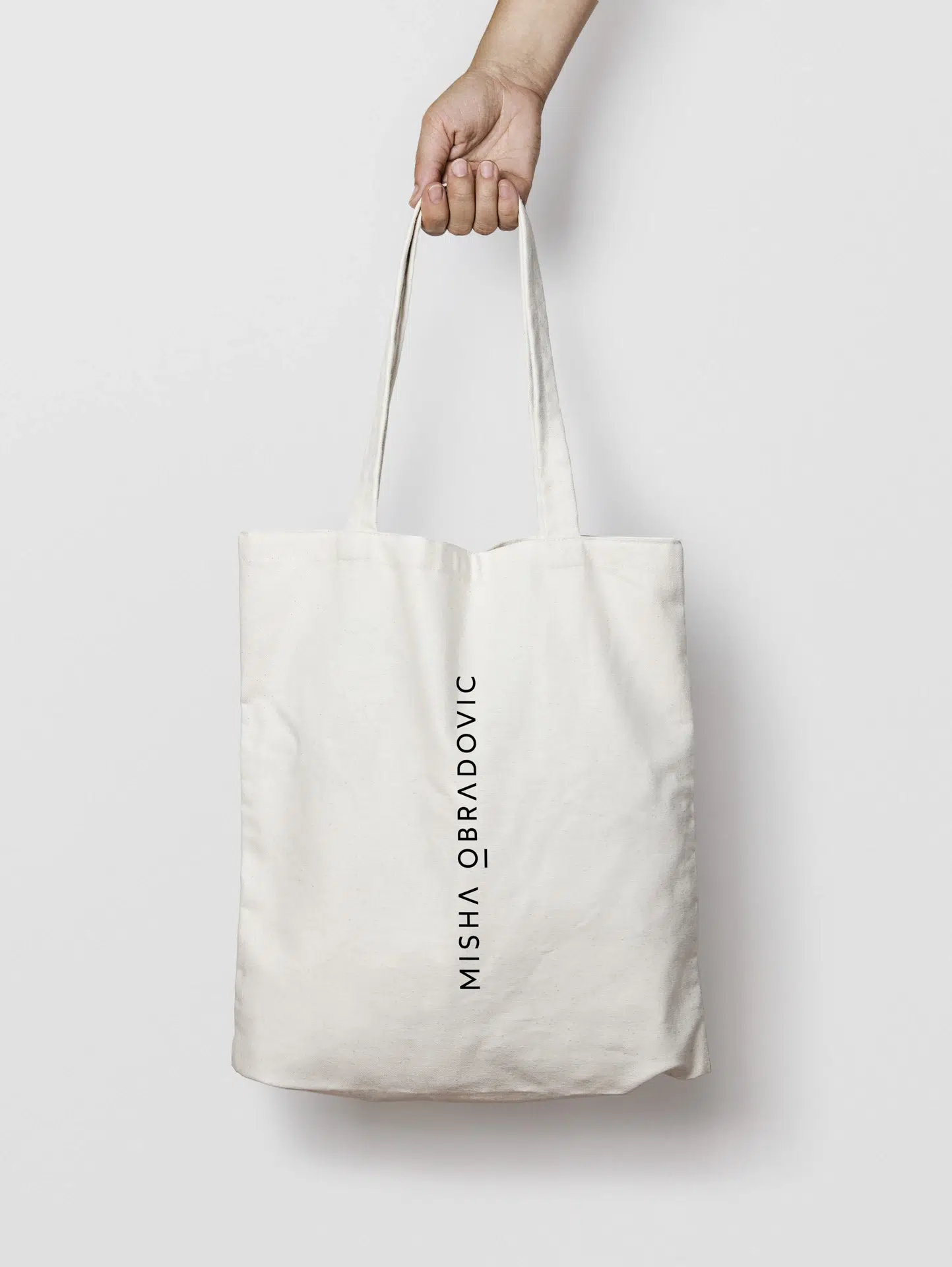 Misha Obradovic brand identity with monochrome tones, sharp typography, and editorial layouts that showcase fashion and cultural photography with intimacy.