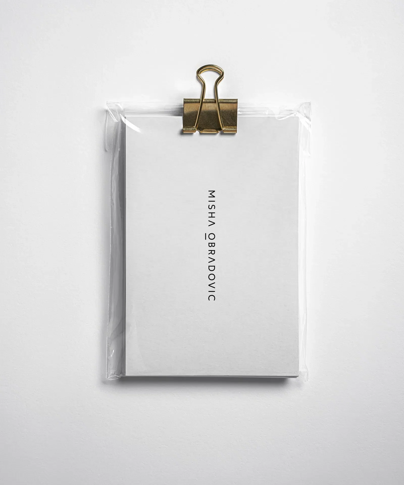Misha Obradovic brand identity with monochrome tones, sharp typography, and editorial layouts that showcase fashion and cultural photography with intimacy.