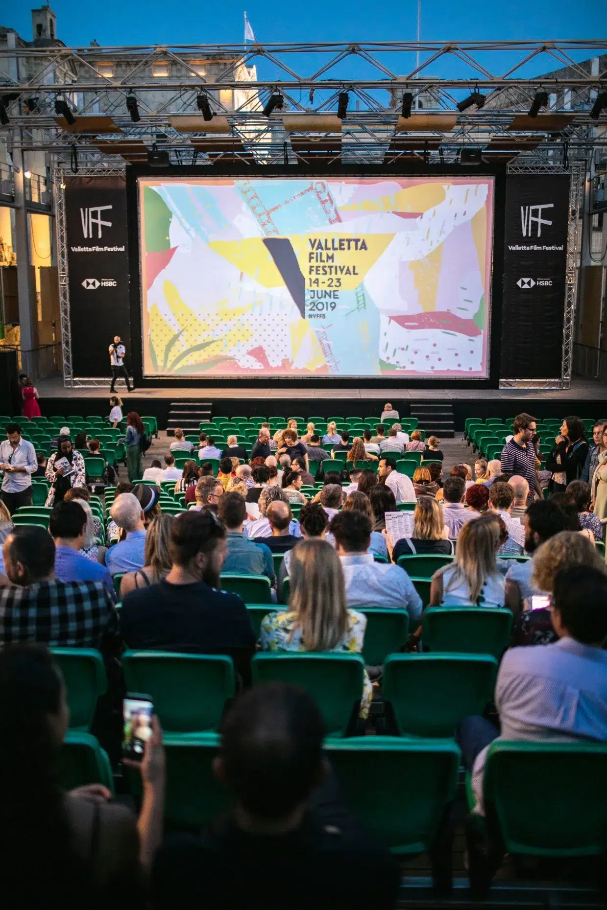 Visual identity series for Valletta Film Festival featuring annual poster designs, merchandise, programs, and motion graphics reflecting the citywide film celebration.